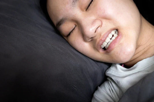 An image shows a girl's discomfort due to bruxism while she is sleeping