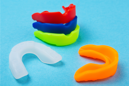 An image shows different colors of boxing mouth guards