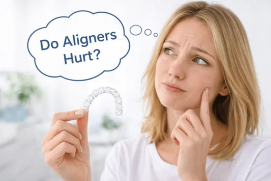 A woman holding aligners and thinking if they hurt
