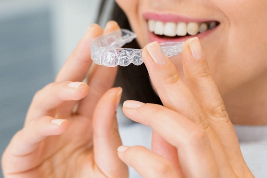 A girl putting on clear aligners