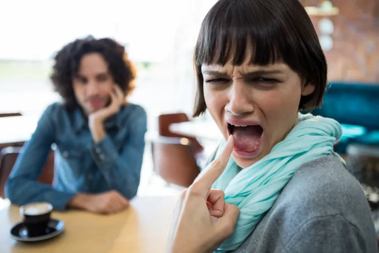 Woman showing burns on her tongue.