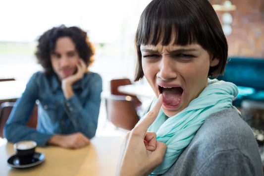 Woman showing burns on her tongue.