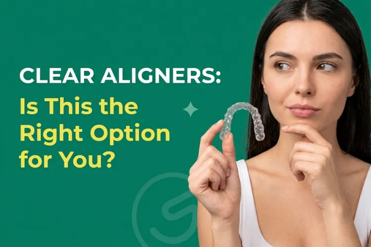 Woman holding a clear aligner in her hand with a thoughtful expression. 