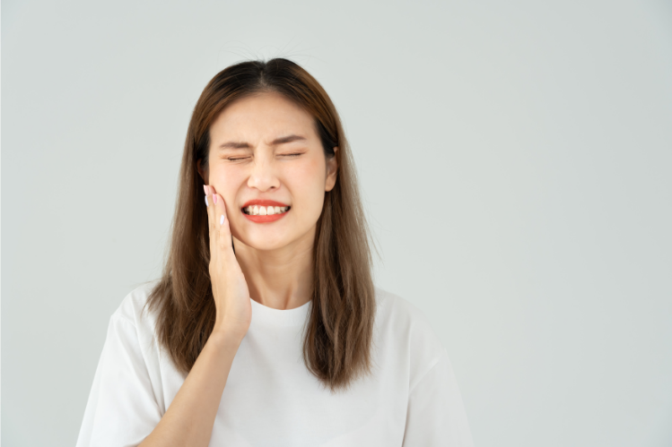 A woman experiencing discomfort after wearing retainers