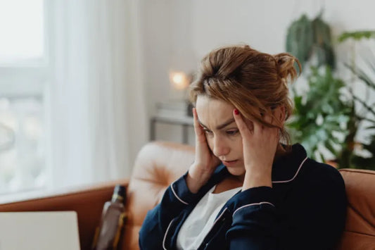 A girl suffering from a headache due to teeth grinding all night.