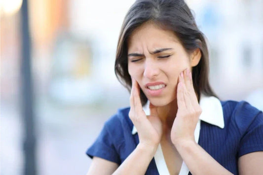 A woman suffering from TMJ pain on both sides