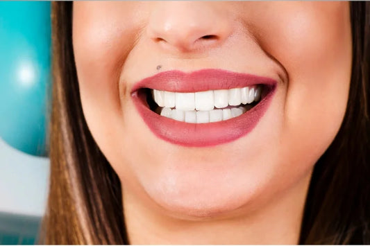 A woman smiles and showcases a beautiful set of white pearlies 