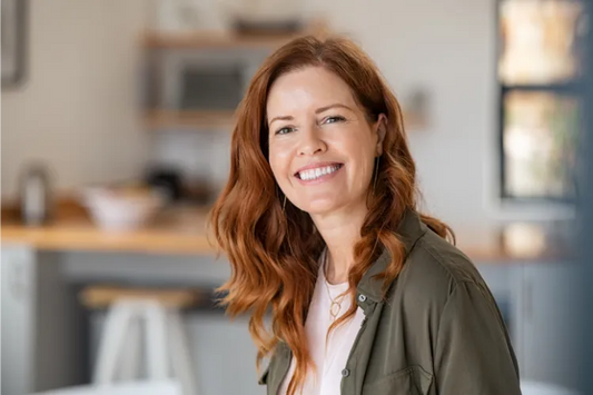 A woman smiling widely after teeth straightening