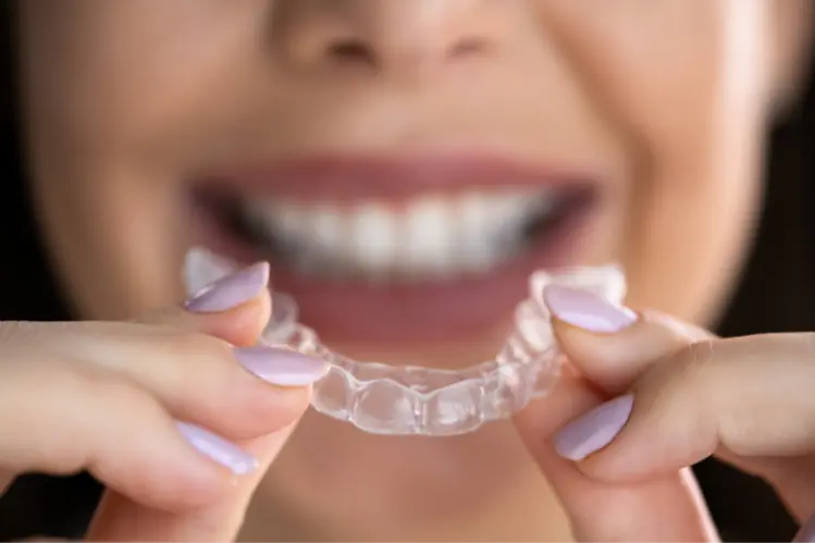 A girl applying clear aligners