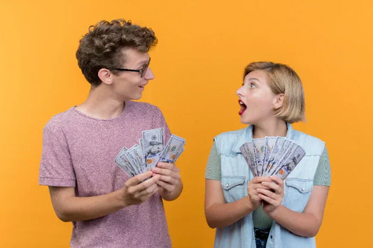 An image of a teenage girl and a boy holding money 